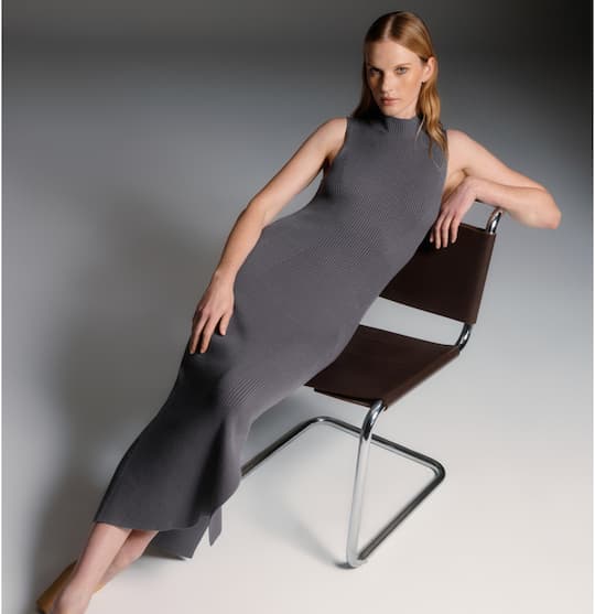 Model is wearing grey crewneck maxi dress.